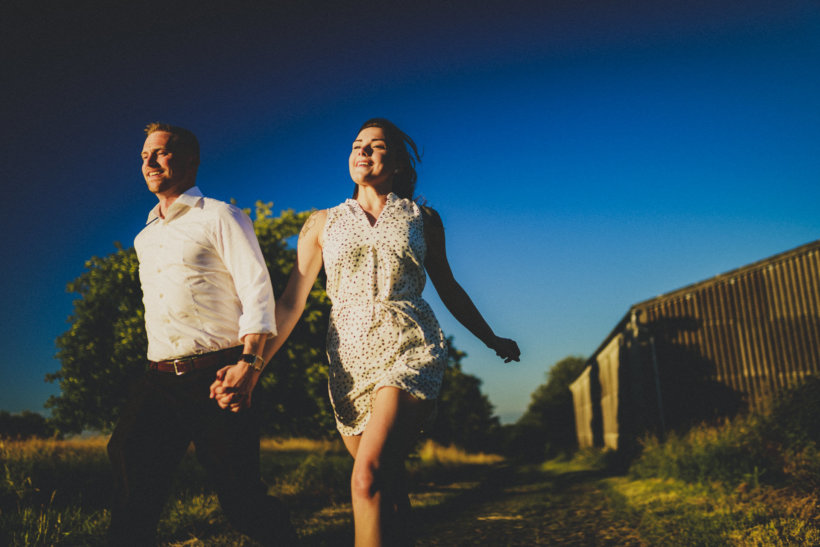 verliebtes Paar läuft zusammen einen Feldweg entlang, den richtigen hochzeitsfotograf finden, rossi photography